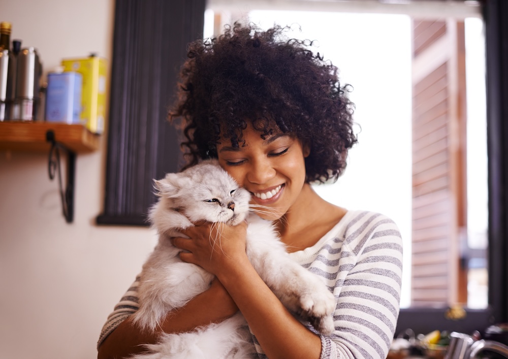 Young woman with cat at her pet friendly studio apartments